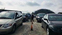 A row of cars line up outside the Harrison County Superior Court Saturday. Parents and guardians inside are waiting for a free car seat courtesy of the prosecutor's office and forfeited cash.&nbsp; Staff photo by Erin Walden