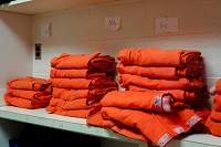 Clean orange jumpsuits sit on a shelf in the Clementine B. Barthold Juvenile Detention Center. Staff photo by Josh Hicks
