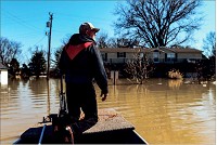 n this file photo, Utica resident Doug Sneed maneuvers his boat through the flood waters in Utica in February. Sneed, along with other volunteers, assisted emergency responders in surveying the area and helping residents to safety. Staff photo by Tyler Stewrt