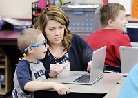 Meghan Hersberger helps Finnley Toney log onto an online quiz in her first-grade class at Frankton Elementary School on Friday, April 6, 2018. Staff photo by Don Knight