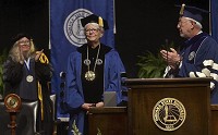  Madam President: Deborah J. Curtis (center) acknowledges the applause of the audience Friday after her installation as Indiana State University&rsquo;s 12th president. She wears around her neck the presidential medallion. Board of Trustees chair David Campbell (right) applauds as Faculty Senate chair Liz Brown observes. The ceremony was conducted in Hulman Center. Staff photo by Joseph C. Garza
