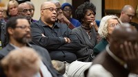 Visitors in the crowd view graduation data on students in Indiana during an open forum with members of Indiana's state legislature concerning the challenges of African American college students, faculty, and staff. April 18, 2018. (Kyle Telechan / Post-Tribune)