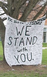 Bearing the names of students from across the DePauw campus, a banner at the corner of College Avenue and Hanna Street expresses support for people of color, LGBTQ and other marginalized students on campus. The campus is reacting this week to multiple recent bias incidents on campus.
Banner Graphic/JARED JERNAGAN