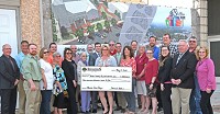 Wells County Foundation Board members and board members for Bluffton NOW! pose with a $300,000 check from the foundation to be used toward the estimated $1.1 million Wells County Courthouse Plaza project. With the check, the foundation retains naming rights for the project. A name for the plaza has not yet been selected. Staff photo by Glen Werling