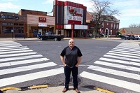 Brad Strom poses in front of the Crown Theater in dowtown Crown Point. He recently purchased it with plans to try and fill the entertainment voide left by the closing and demolition of the Star Plaza Theatre. Staff photo by Kale Wilk