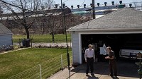 Neighbors Jeff Myers, 69, left, and Steve Krajnik, 80, talk in Hammond, Ind. on May 1, 2018. Federated Metals operated the former smelter in the background from 1937 to 1983. Krajnik has lived here his entire life. (Zbigniew Bzdak / Chicago Tribune)