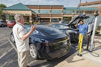 DRS. JOHN MARVEL,&nbsp;left, and Ganesh Ramachandran chat while hooking up their Teslas to the hospital charging station. Staff photo by Fran Ruchalski | Pharos-Tribune
