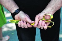McCordsville Town Council president Larry Longman holds the ceremonial gold scissors for Thursday's Tri-County Connector ribbon-cutting ceremony in Geist. Staff photo by Tom Russo