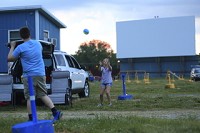 BALL:Aly and Colin Green of Blufton play catch before dusk. The parking lot slowly filled up at twilight with most people from outside Huntington&rsquo;s city limits. Staff photo by Andrew Maciejewski