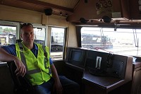 Arin Johnson sits in the conductor's seat of a locomotive at the Norfolk Southern railyard in Elkhart. Staff photo by Jordan Fouts