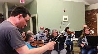 Director Owen Heritage leads the New Albany Community Orchestra in a performance of a classical piece. The orchestra is part of the Kentuckiana Association of Musicians and Singers. | STAFF PHOTO BY BROOKE MCAFEE