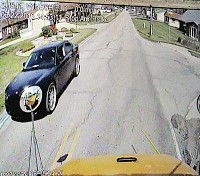 This photo of video footage from an East Noble bus shows a car passing the bus on Riley Road while the stop arm is out. A new system is helping capture images of license plates and drivers, making it easier for police to track down and ticket violators. Staff photo by Steve Garbacz