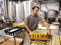 David Thieme stacks cases of Boiler Gold American Ale fresh off the canning line Thursday, August 31, 2017, at People's Brewing Company, 2006 N. 9th Street in Lafayette. &nbsp;(Photo: John Terhune/Journal &amp; Courier)