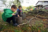 Boulevard Elementary preschool students Everson Chasshir and Hudson Weaver collect bugs Thursday at a cabin with plans to feed them to frogs back in the classroom. Staff photo byTim Bath