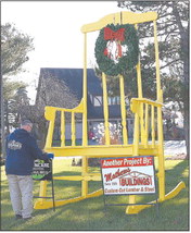 Steve Mathews

places signs in front of the giant yellow rocking chair Dec. 7. Mathews and Jared Goltz purchased the chair during We Care Telethon. The chair now sits in front of Mathews Buildings on Indiana 29, just north of Indiana 26. Tim Bath | Kokomo Tribune
