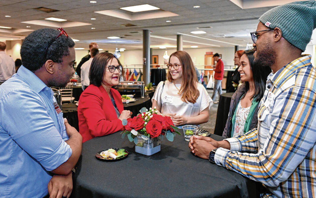 UIndy President Dr. Tanuja Singh, second from left, speaks to international students and alumni during a receptin as part of her inauguration as the 10th president of the university  April 4, 2024. Photo by D. Todd Moore, University of Indianapolis
