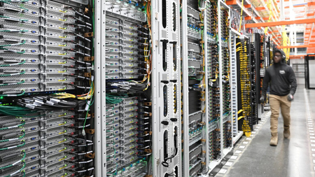 A worker inside an AWS data center. (Photo from Amazon.)